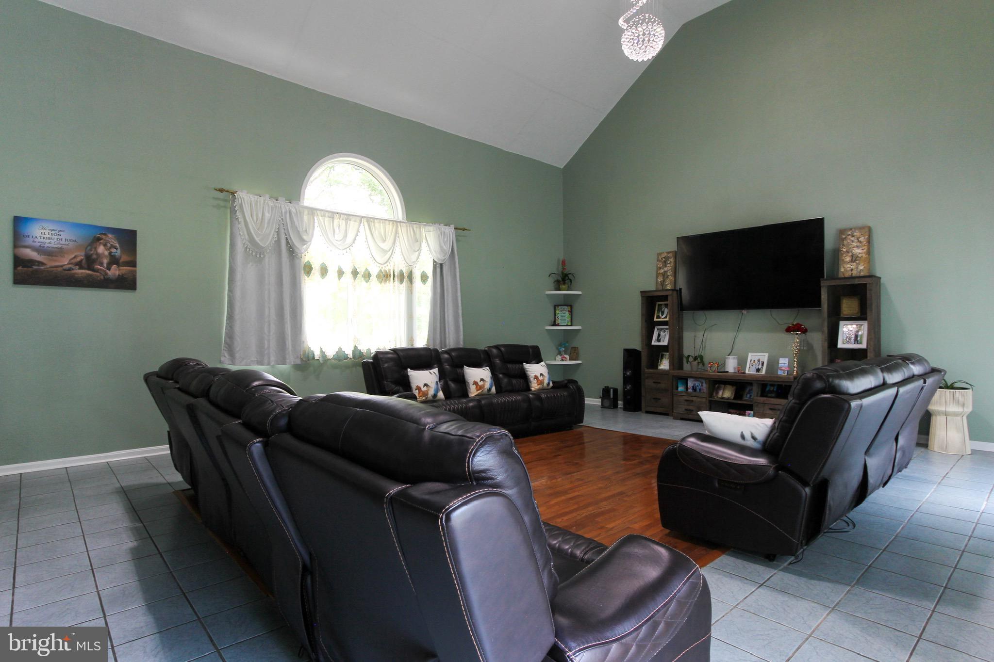 911 South Wieker Road Severn, MD 21144 - Photo 29 of 73 a living room with furniture and a flat screen tv