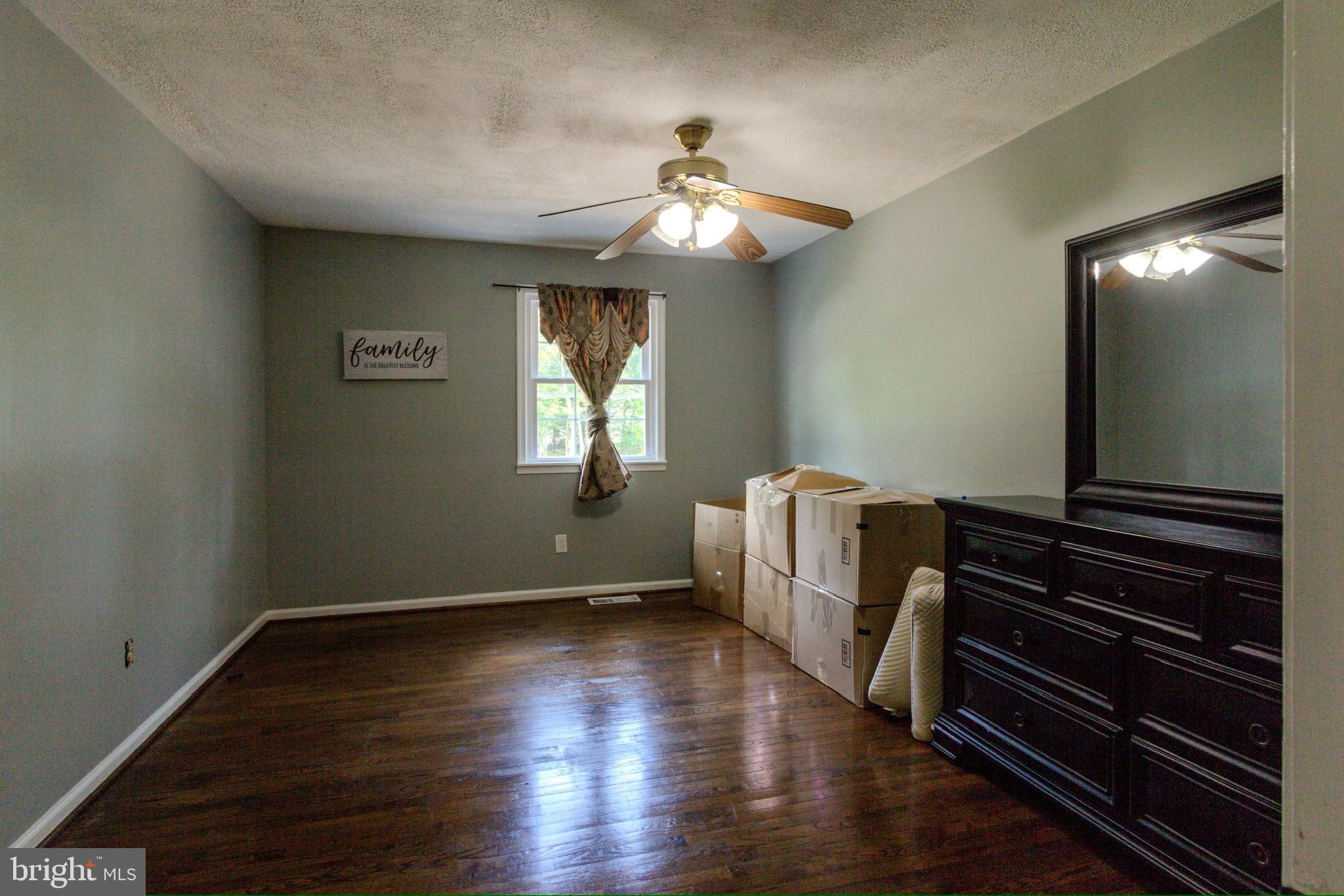 911 South Wieker Road Severn, MD 21144 - Photo 30 of 73 a view of an empty room with wooden floor and a window