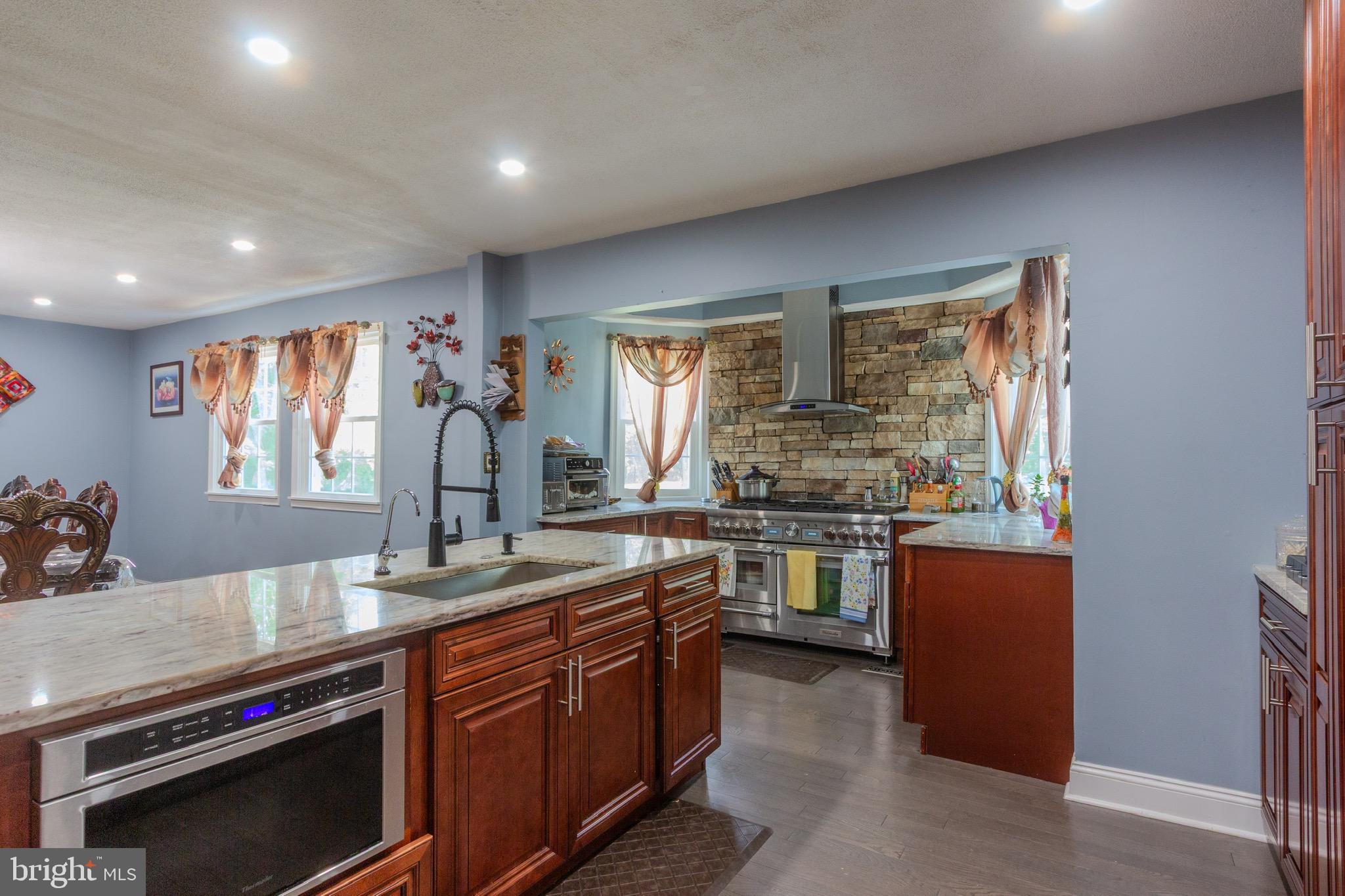 911 South Wieker Road Severn, MD 21144 - Photo 36 of 73 a kitchen with stainless steel appliances granite countertop a stove and a sink