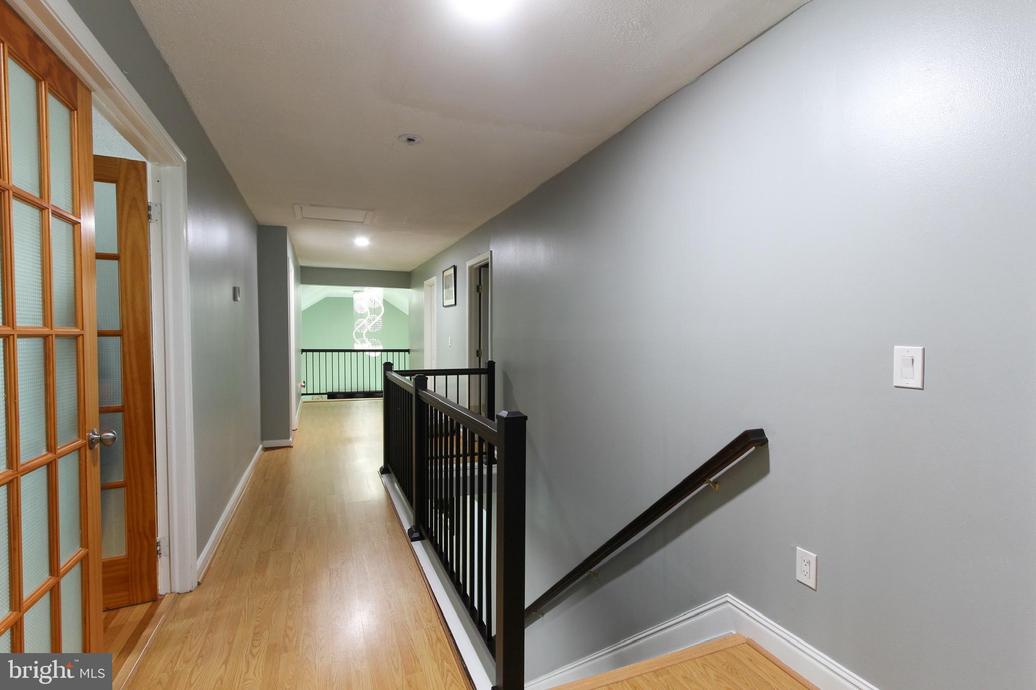 911 South Wieker Road Severn, MD 21144 - Photo 45 of 73 a view of a hallway with wooden floor and staircase