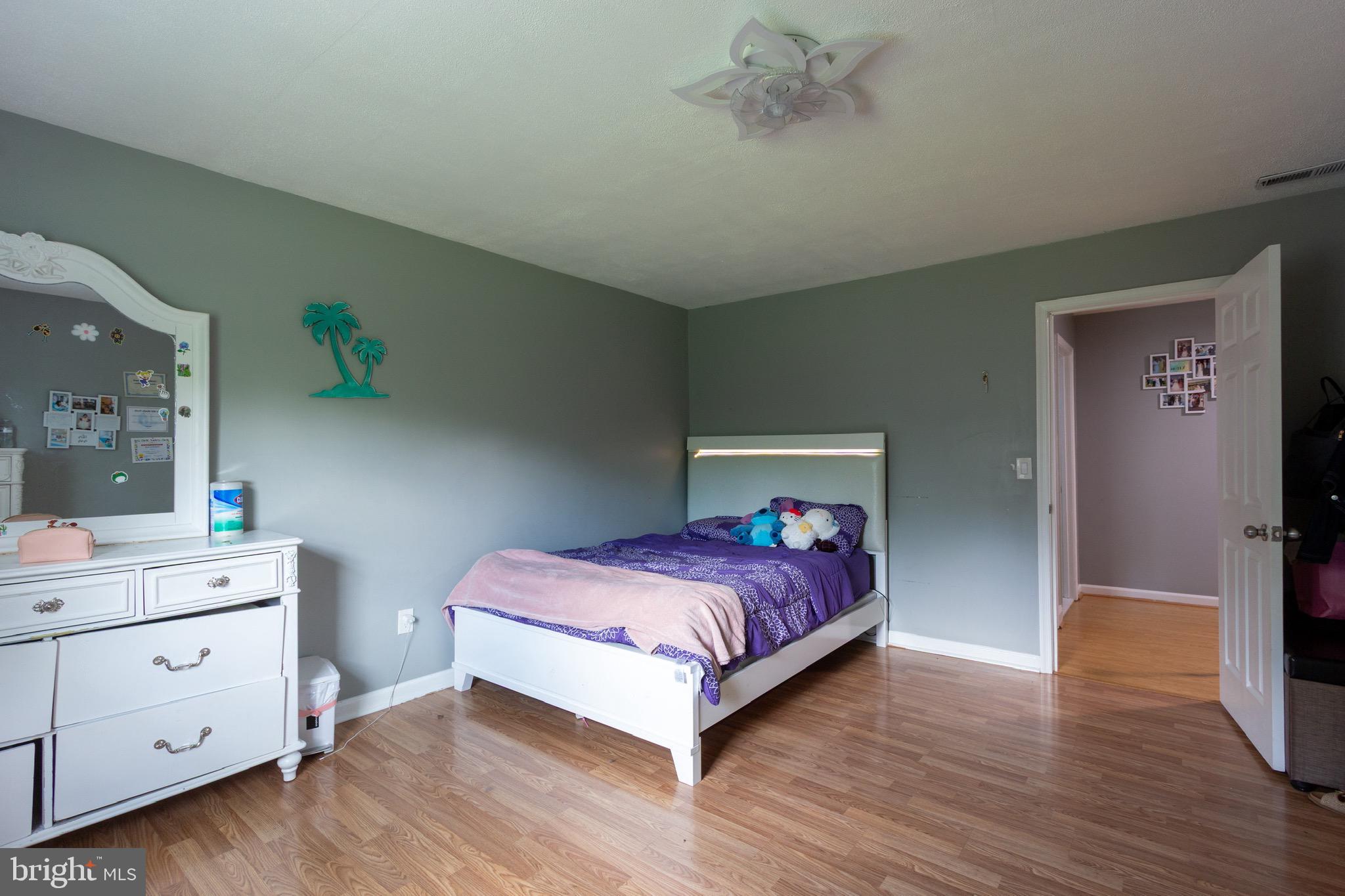 911 South Wieker Road Severn, MD 21144 - Photo 47 of 73 a bedroom with a bed and a table in it