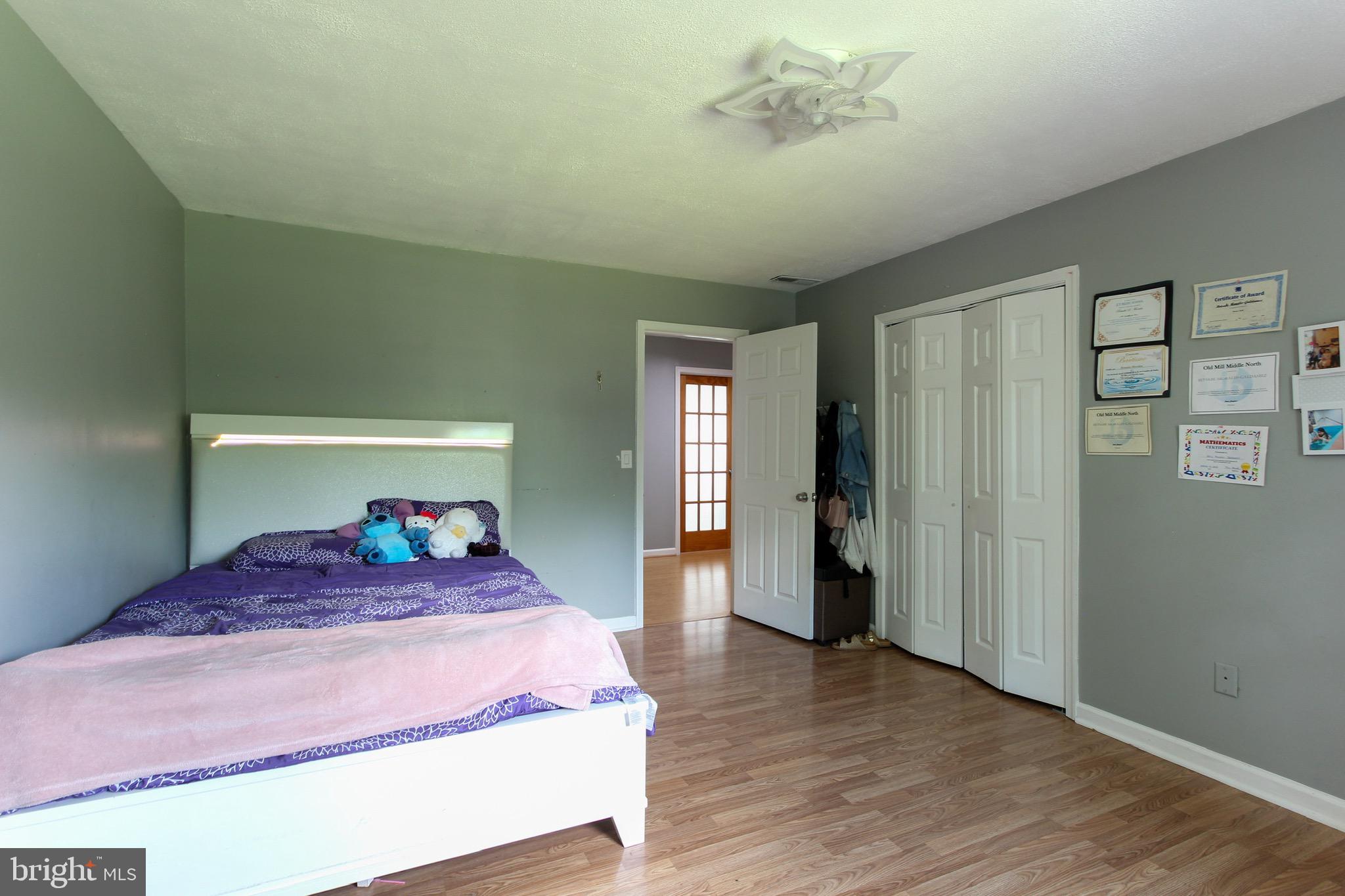 911 South Wieker Road Severn, MD 21144 - Photo 48 of 73 a bedroom with a large bed and wooden floor