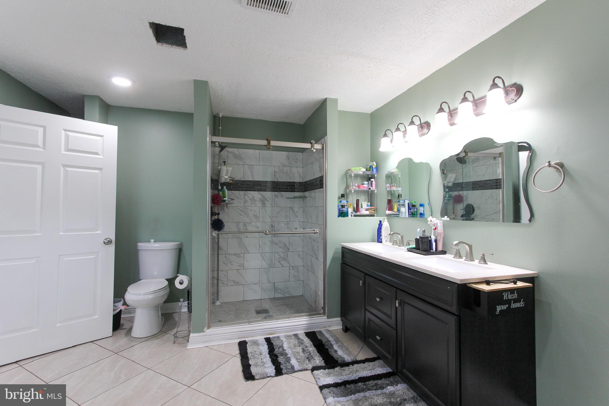 911 South Wieker Road Severn, MD 21144 - Photo 52 of 73 a bathroom with a sink mirror and toilet