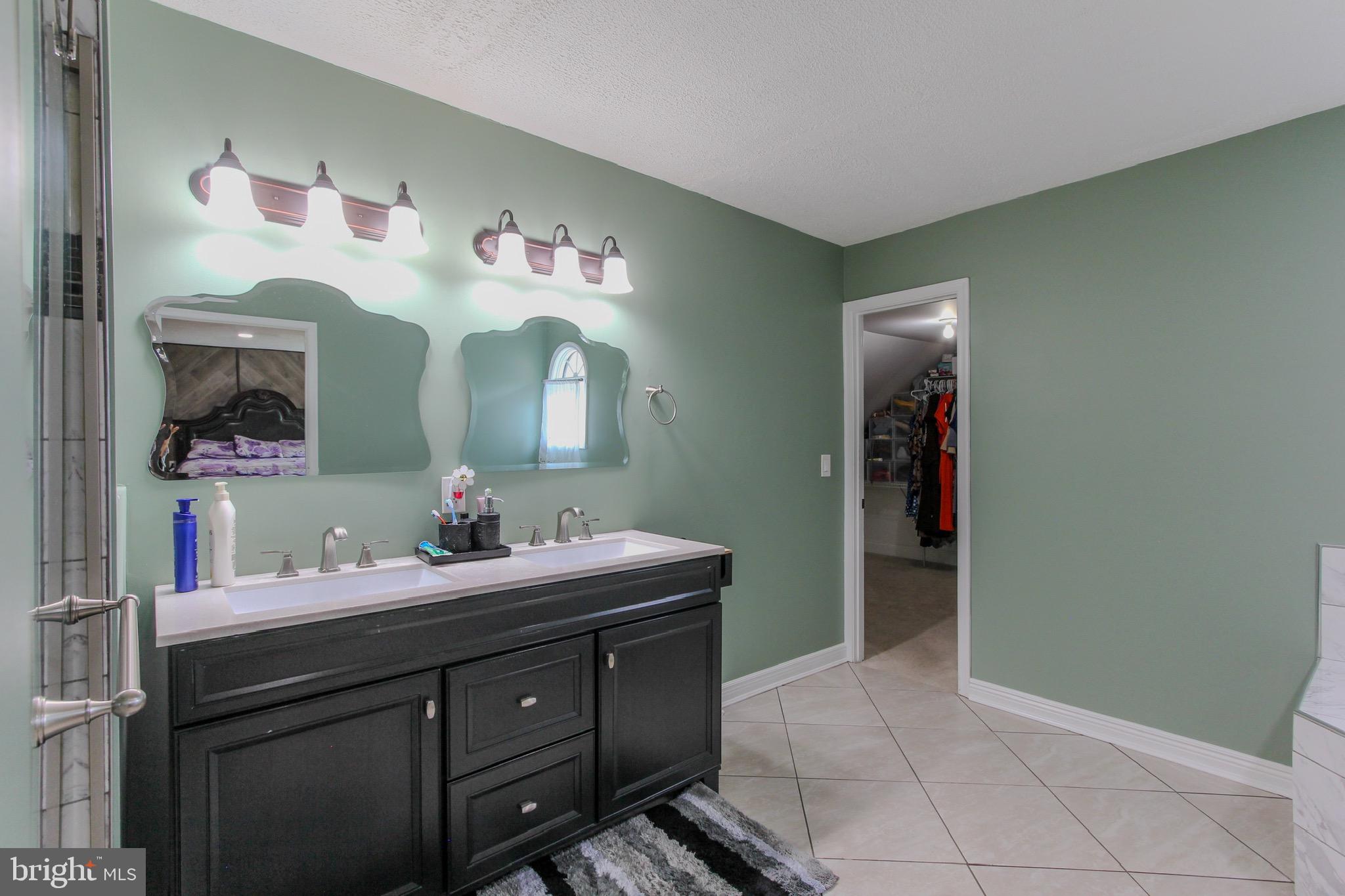 911 South Wieker Road Severn, MD 21144 - Photo 53 of 73 a bathroom with a sink and a mirror