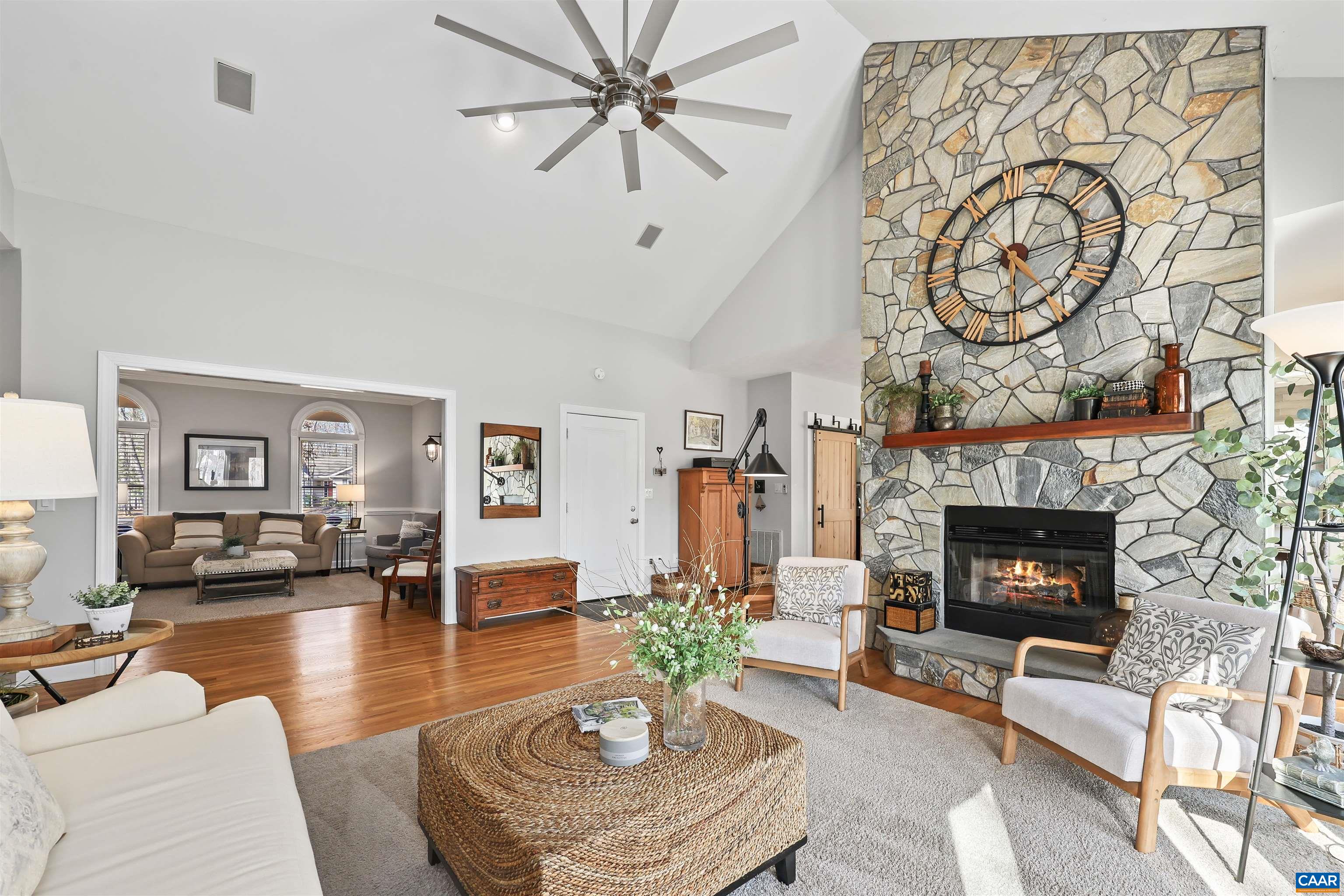 16 Oak Grove Road Palmyra, VA 22963 - Photo 14 of 53 a living room with furniture a clock and a fireplace