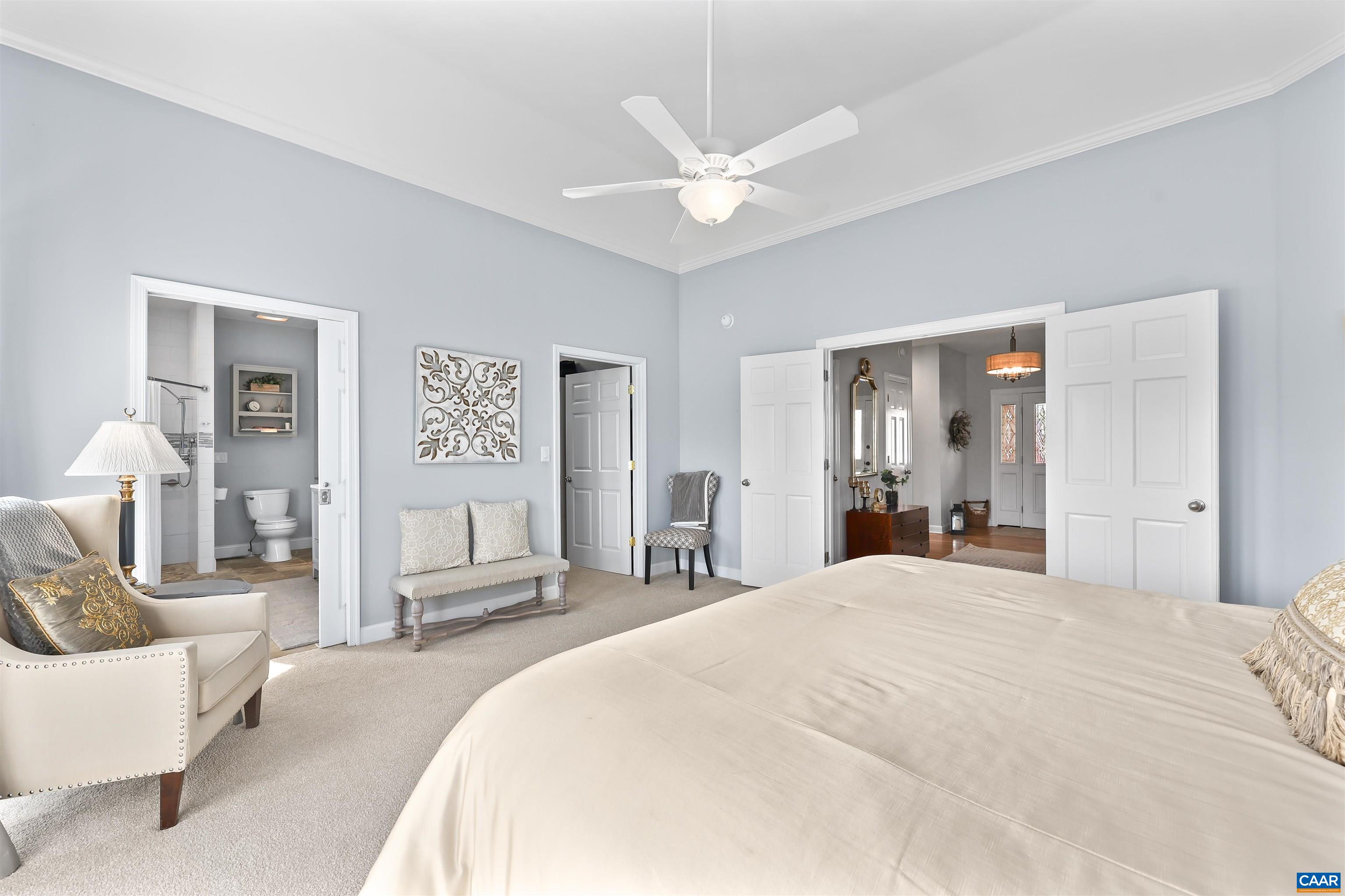 16 Oak Grove Road Palmyra, VA 22963 - Photo 25 of 53 a bedroom with a large bed and a chandelier