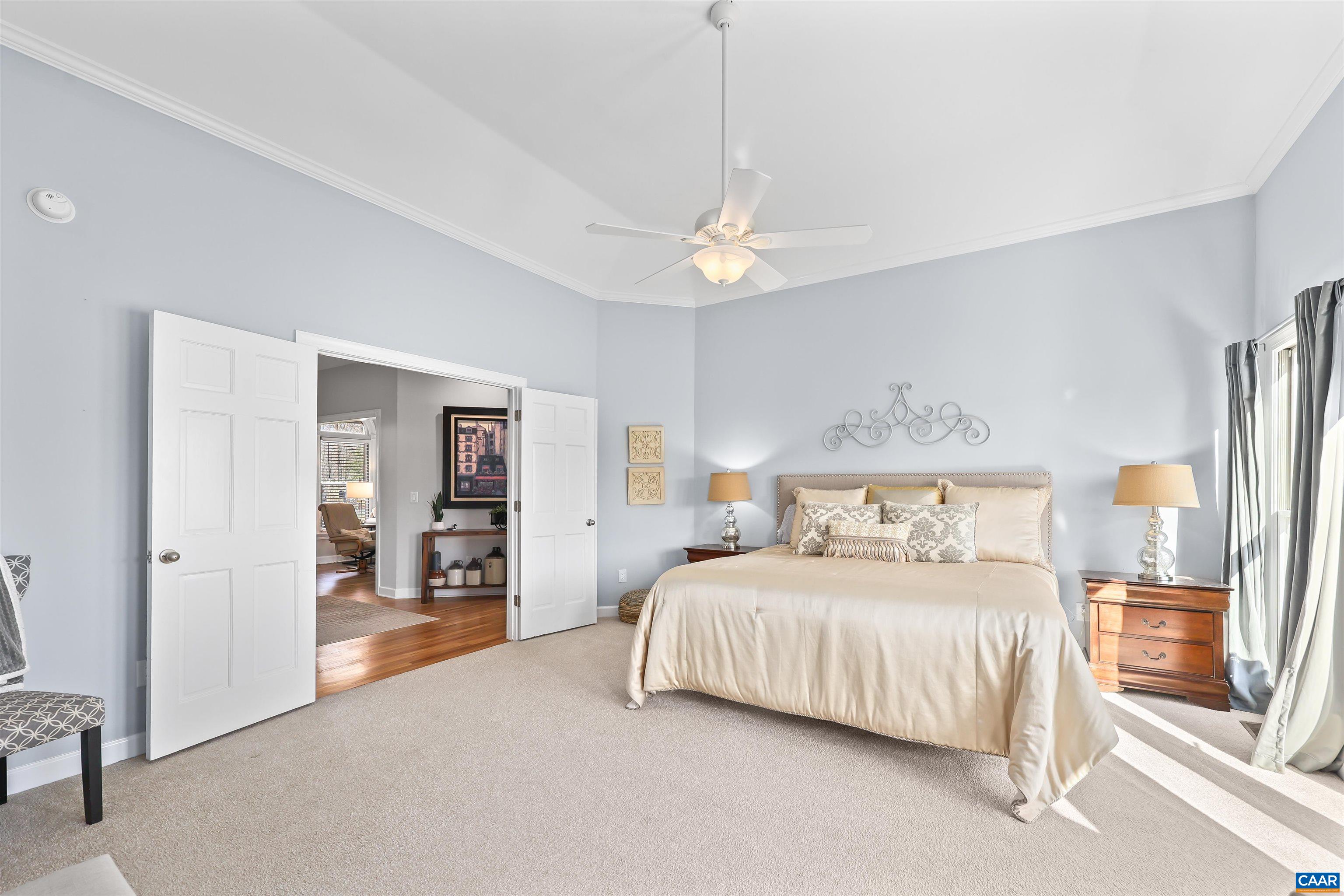 16 Oak Grove Road Palmyra, VA 22963 - Photo 26 of 53 a bedroom with a large bed and a chandelier