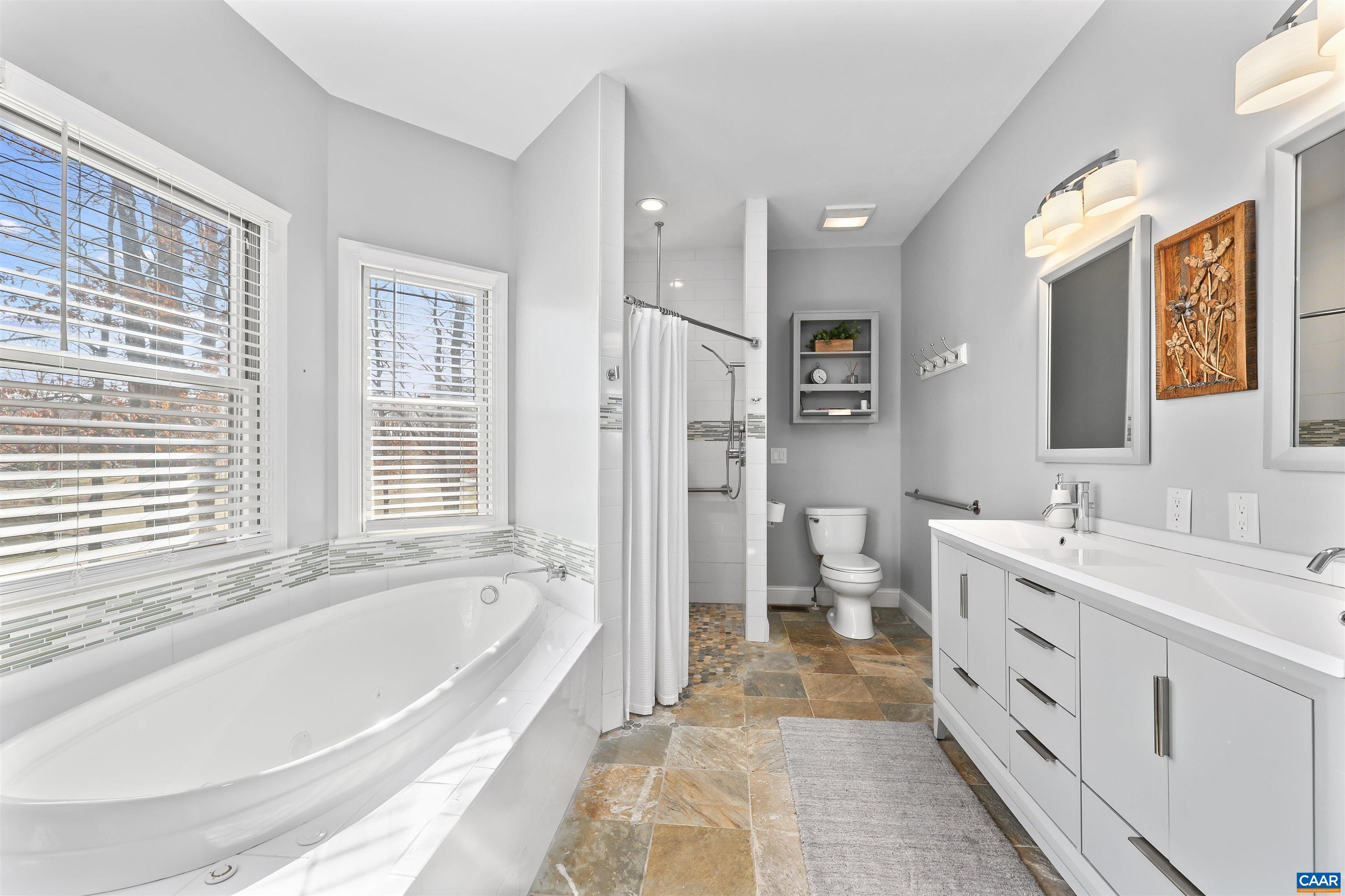 16 Oak Grove Road Palmyra, VA 22963 - Photo 27 of 53 a spacious bathroom with a tub sink and mirror