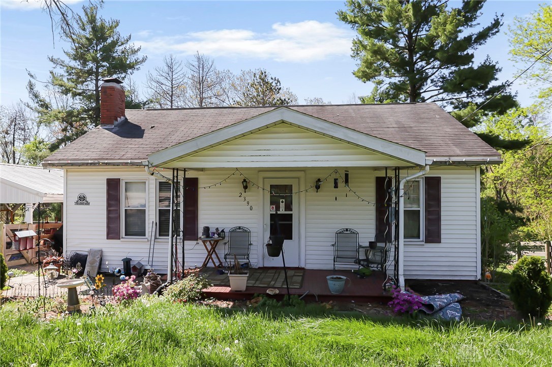 This charming home features a welcoming porch, perfect for enjoying peaceful outdoor moments.