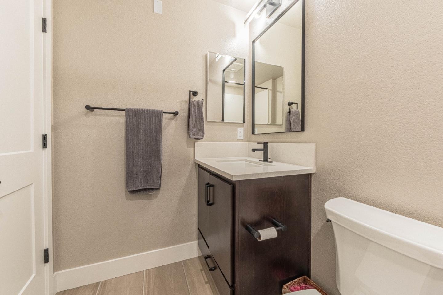 135 8th Street Marina, CA 93933 - Photo 49 of 69 a bathroom with a sink toilet and mirror