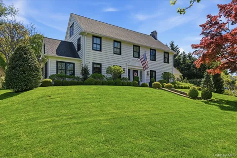a front view of house with yard and green space