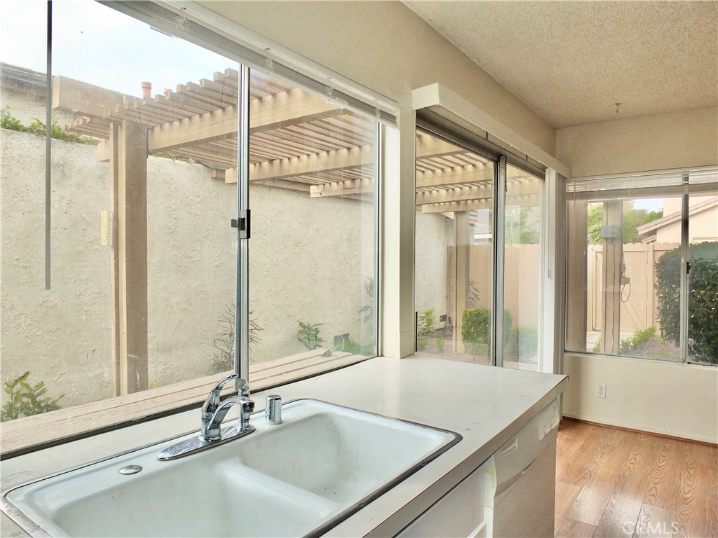14431 Raintree Road Tustin, CA 92780 - Photo 15 of 53 a bathroom with a granite countertop sink and a large window