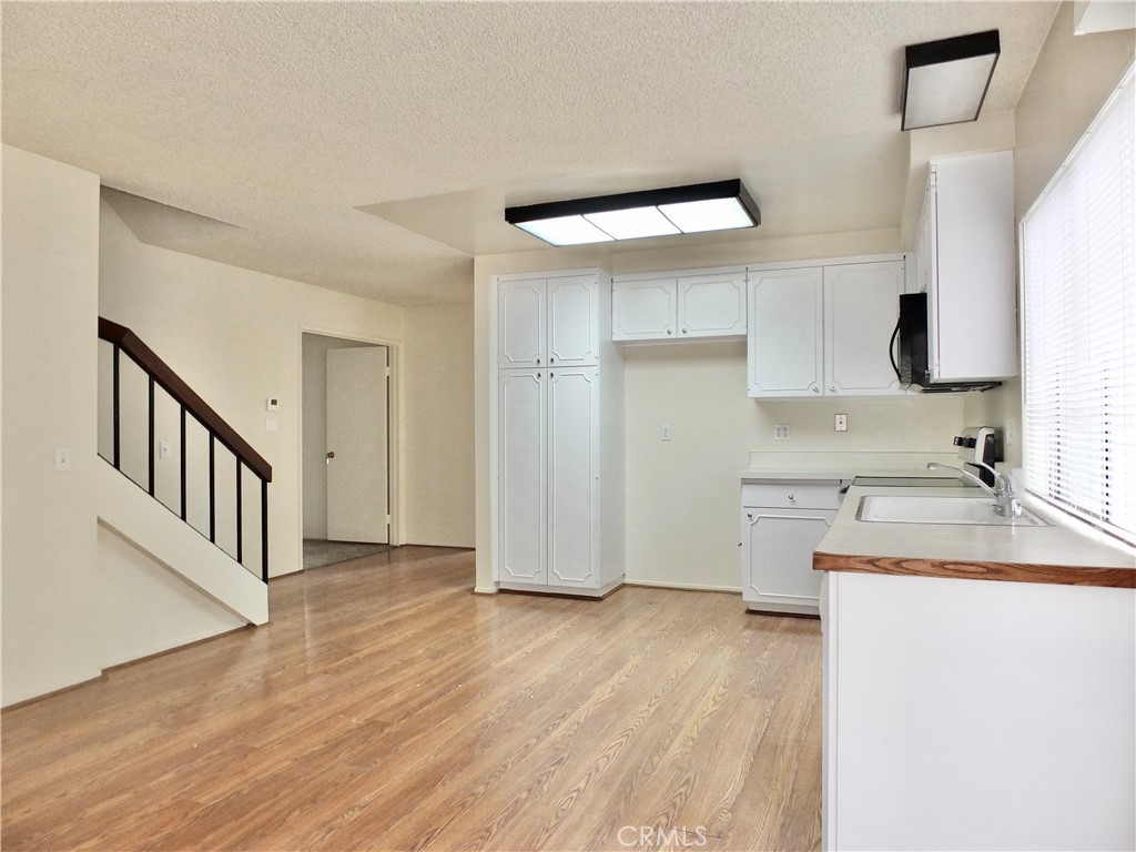 14431 Raintree Road Tustin, CA 92780 - Photo 17 of 53 a kitchen with granite countertop a sink and a stove top oven