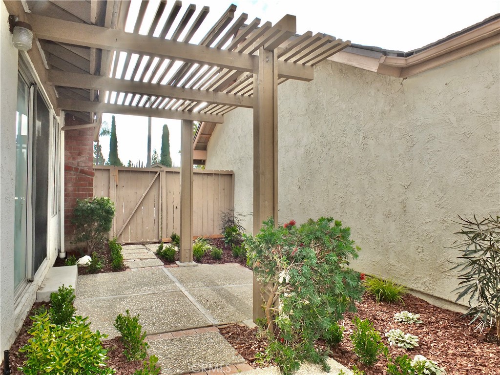 14431 Raintree Road Tustin, CA 92780 - Photo 2 of 53 a view of a pathway along a building