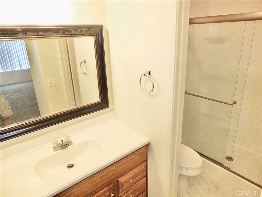 14431 Raintree Road Tustin, CA 92780 - Photo 41 of 53 a bathroom with a sink a toilet and shower