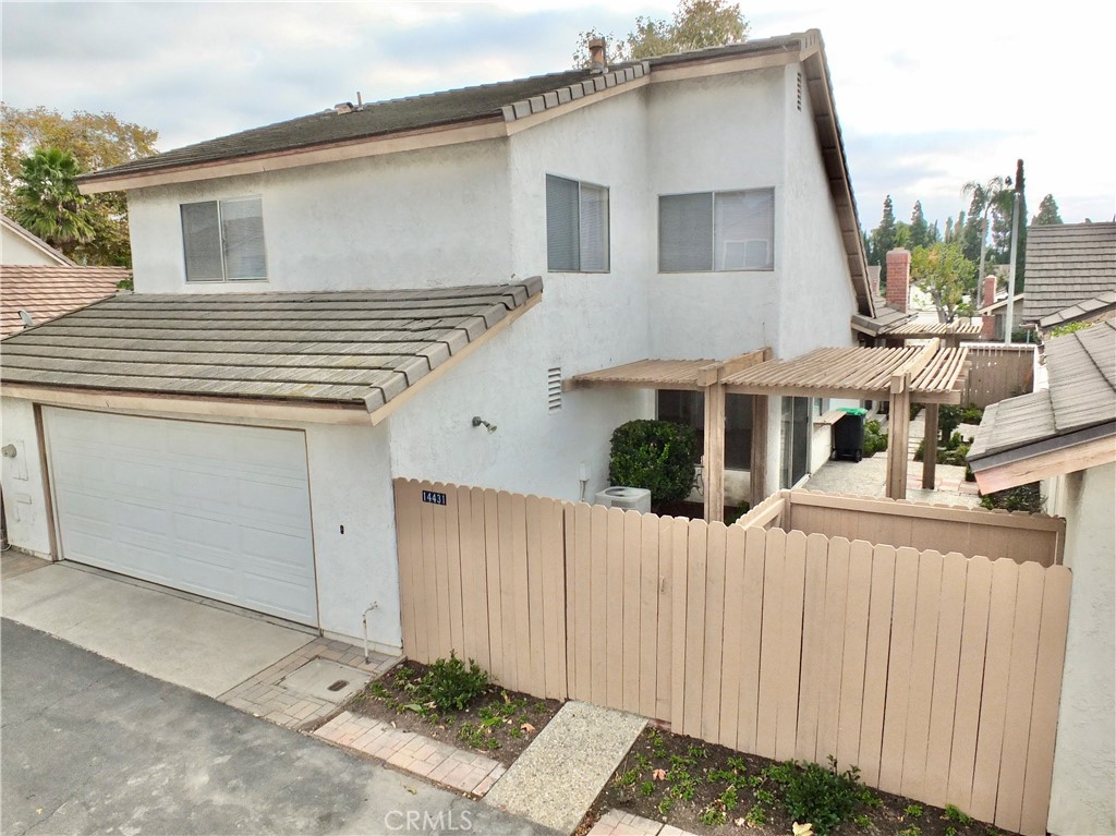 14431 Raintree Road Tustin, CA 92780 - Photo 45 of 53 a front view of a house with a garage