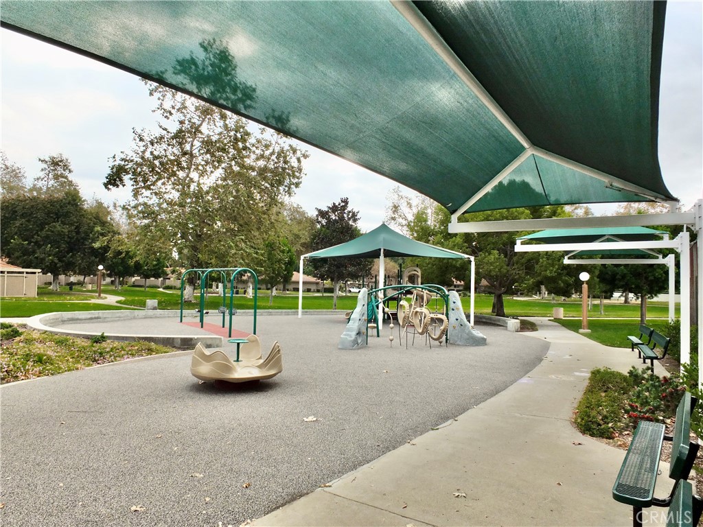 14431 Raintree Road Tustin, CA 92780 - Photo 47 of 53 a view of a patio with a table and chairs under an umbrella