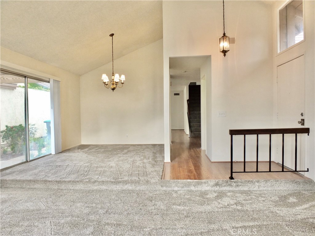 14431 Raintree Road Tustin, CA 92780 - Photo 9 of 53 a view of a livingroom with wooden floor and a chandelier