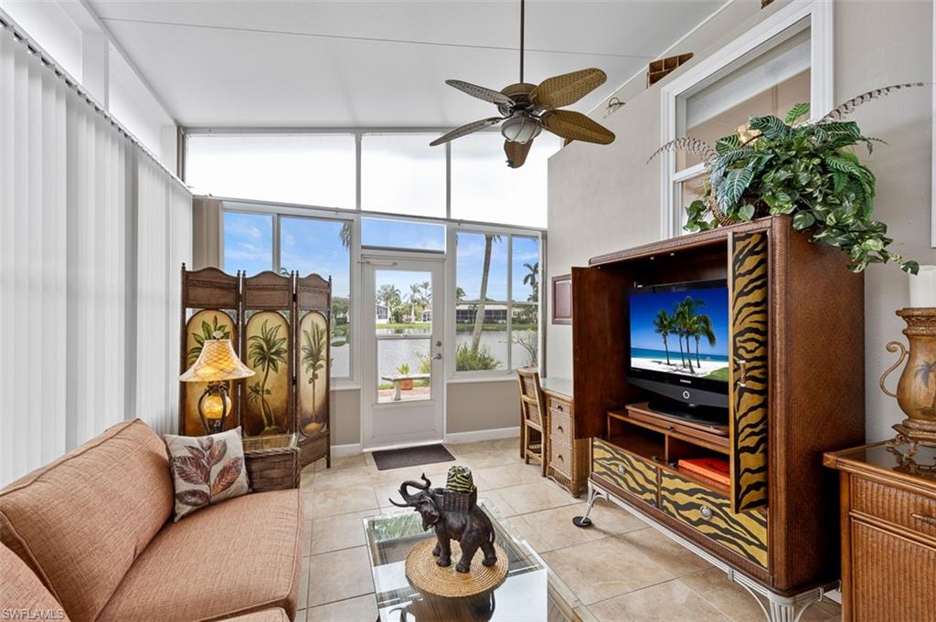 1515 Ruby Lake Point Naples, FL 34114 - Photo 11 of 21 a living room with furniture a window and a flat screen tv