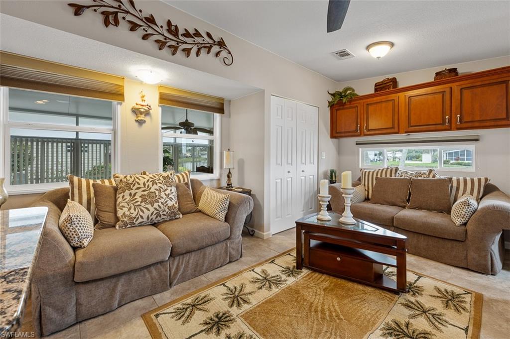 1515 Ruby Lake Point Naples, FL 34114 - Photo 15 of 21 a living room with furniture a rug and a window