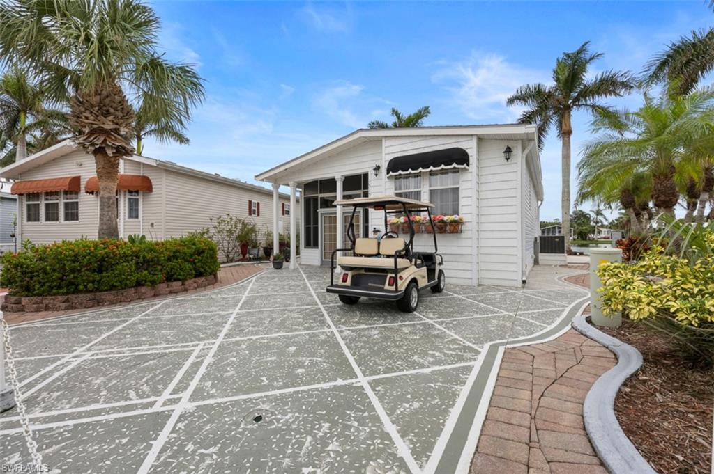 1515 Ruby Lake Point Naples, FL 34114 - Photo 3 of 21 a front view of a house with garden