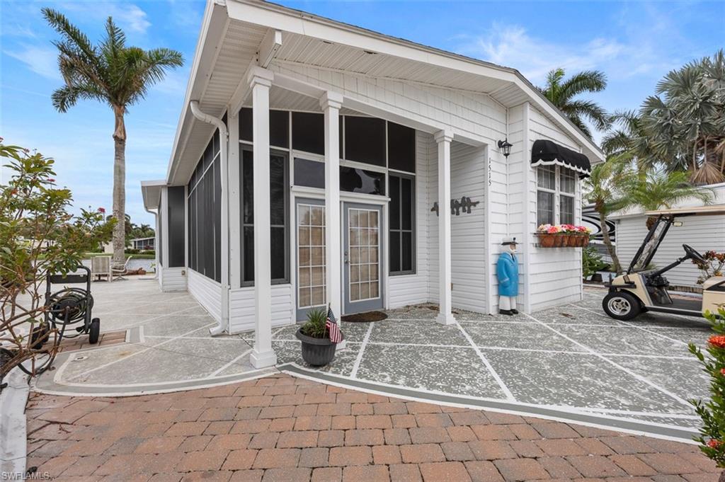 1515 Ruby Lake Point Naples, FL 34114 - Photo 5 of 21 a view of a house with more potted plants and a bench