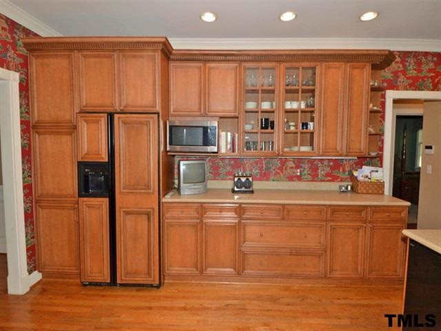 1701 Liatris Lane Raleigh, NC 27613 - Photo 12 of 25 26 CUBIC FOOT GE SIGNATURE REFRIGERATOR W/ CUSTOM WOODEN DOOR PANELS.GLASS FRONT MAPLE CABINET DOORS, WALK-IN PANTRY W/ WOODEN SHELVES Kitchen