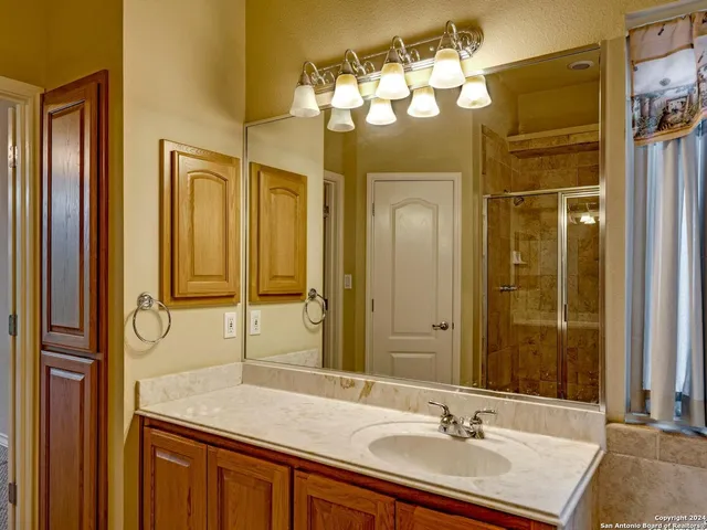 a bathroom with a sink double vanity and a mirror