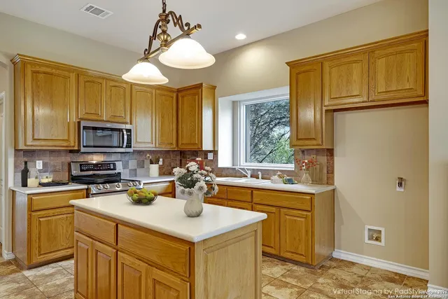 a kitchen with a sink a stove cabinets and refrigerator