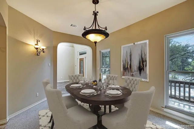a view of a dining room with furniture and window