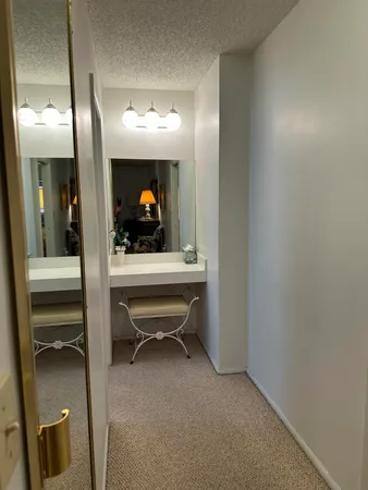 a en suite bathroom with a toilet sink and mirror