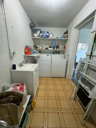 a utility room with sink dryer and bicycles