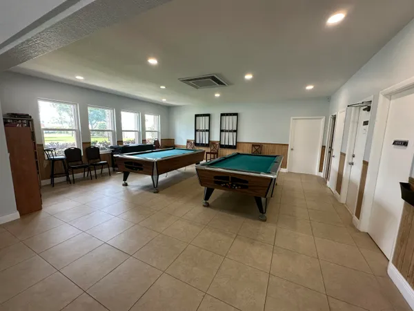a living room with furniture a table and large window