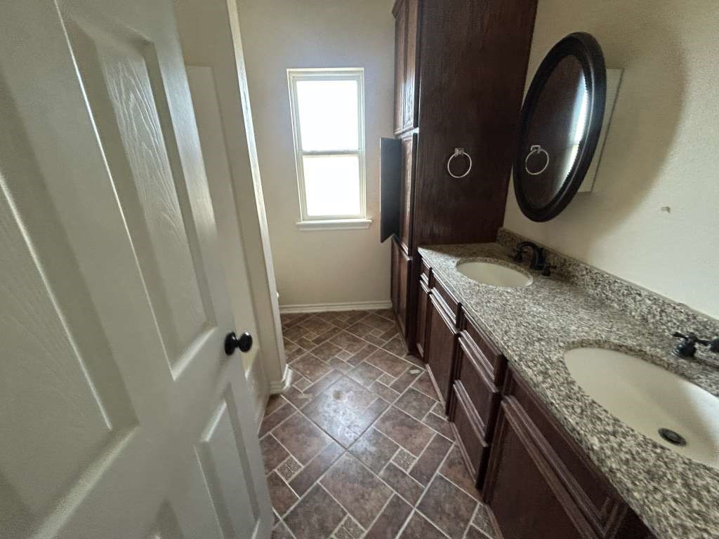 2 Birdwell Road Bedias, TX 77831 - Photo 9 of 11 a bathroom with a granite countertop sink and a mirror