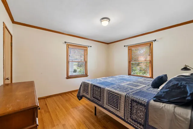 a bed sitting in a bedroom next to a window