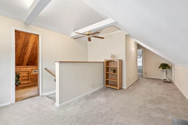 a view of an empty room with cabinet and stairs