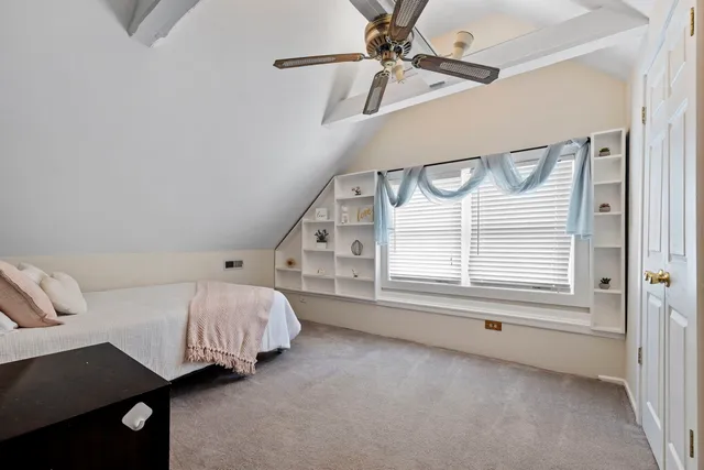 a spacious bedroom with a bed next to a window