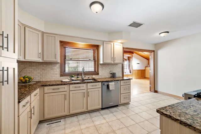a kitchen with stainless steel appliances granite countertop a sink and cabinets