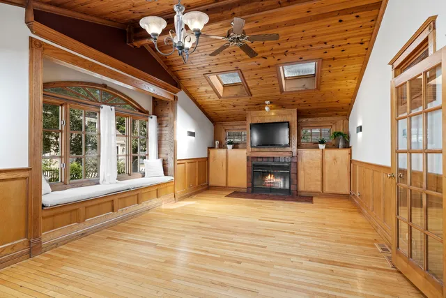 a view of an empty room with a fireplace and a window