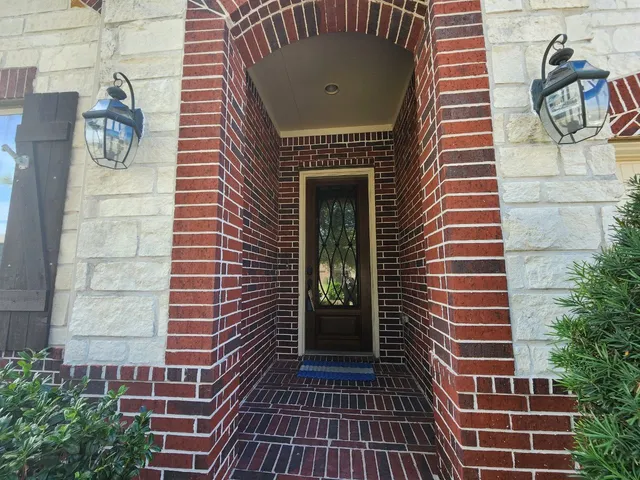a view of a door with a door and wooden floor