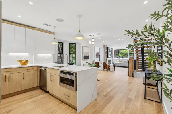 a open kitchen with stainless steel appliances granite countertop a lot of counter space and wooden floors
