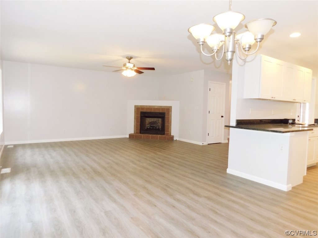 2317 Meherrin Road Meherrin, VA 23954 - Photo 13 of 28 a view of a room with a chandelier fan and wooden floor