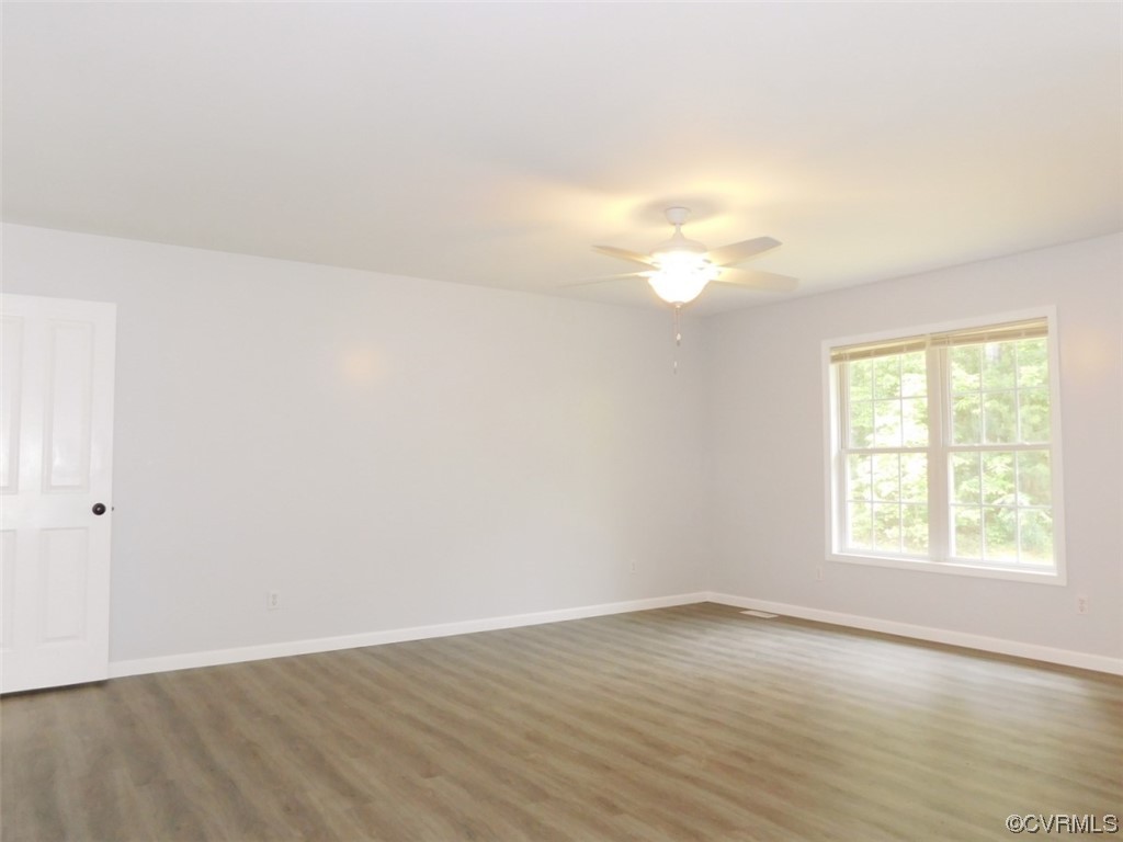 2317 Meherrin Road Meherrin, VA 23954 - Photo 16 of 28 an empty room with wooden floor and windows