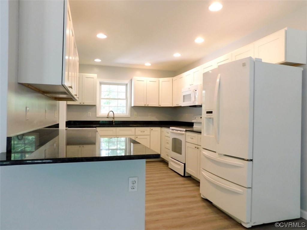 2317 Meherrin Road Meherrin, VA 23954 - Photo 5 of 28 a kitchen with granite countertop white cabinets and white appliances