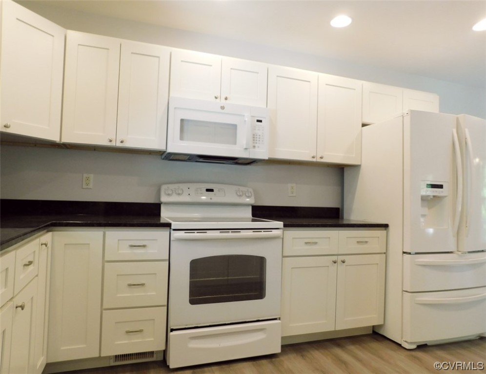2317 Meherrin Road Meherrin, VA 23954 - Photo 7 of 28 a kitchen with white cabinets and white appliances