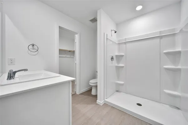 a bathroom with a shower sink and toilet