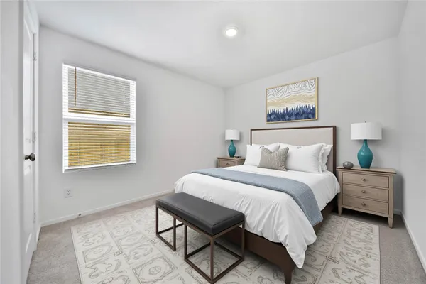 a bedroom with a bed and a painting on the wall