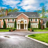 a front view of a house with a yard