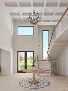 a view of entryway and hall with a dining table