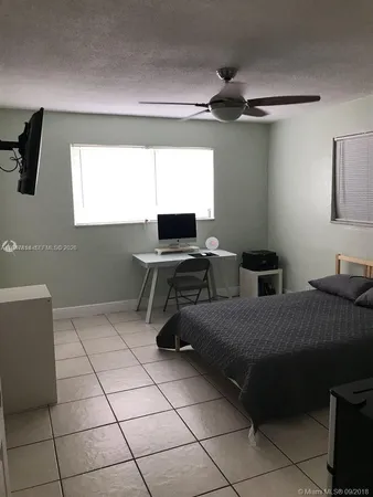 a bedroom with a bed and a desk